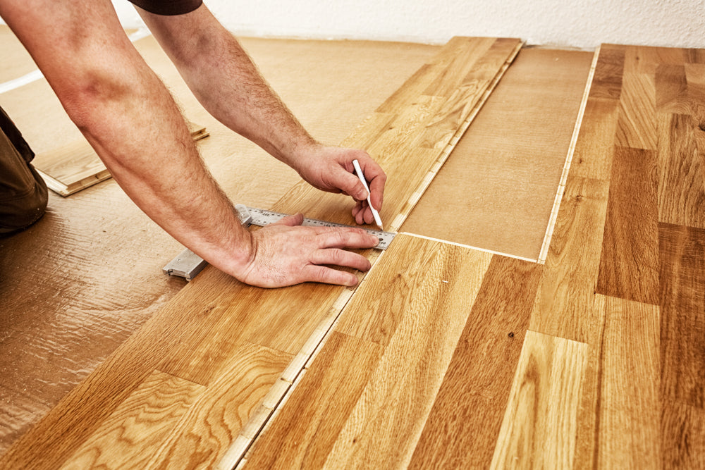 Craftsman installing engineered click system oak wood flooring